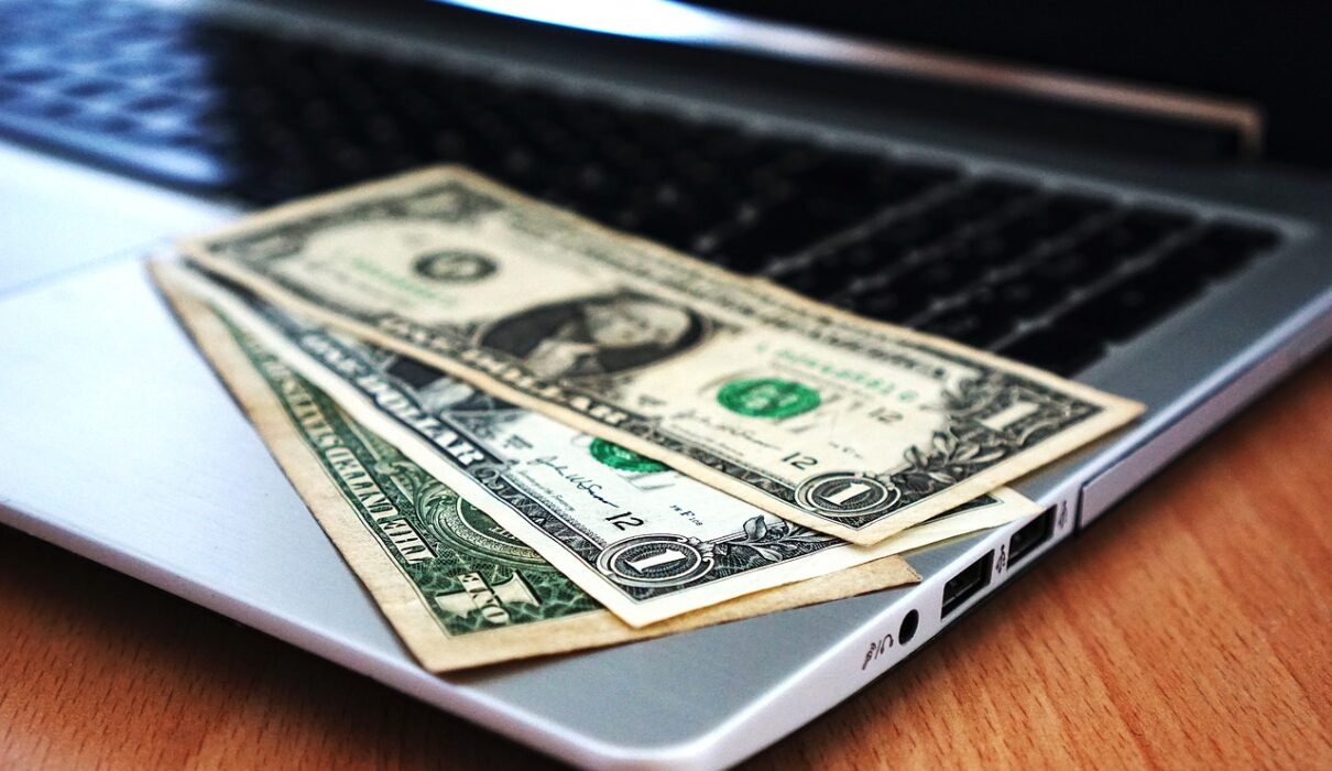 Dollar Bills Placed On Laptop