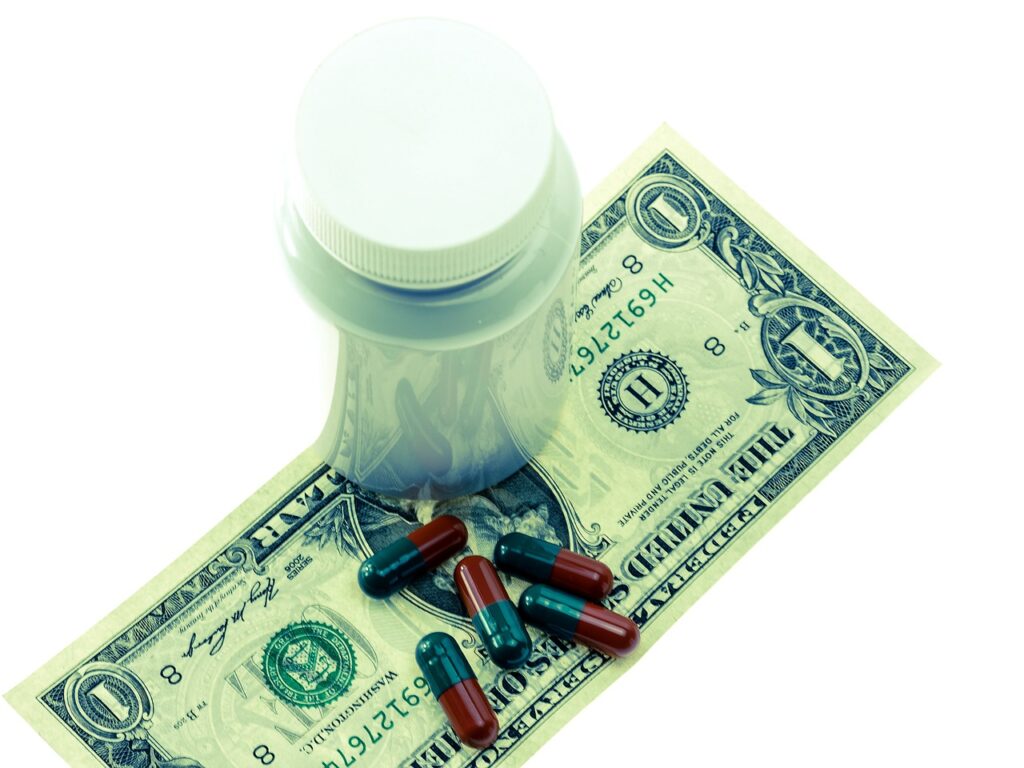 Pill Bottle On Top Of Dollar